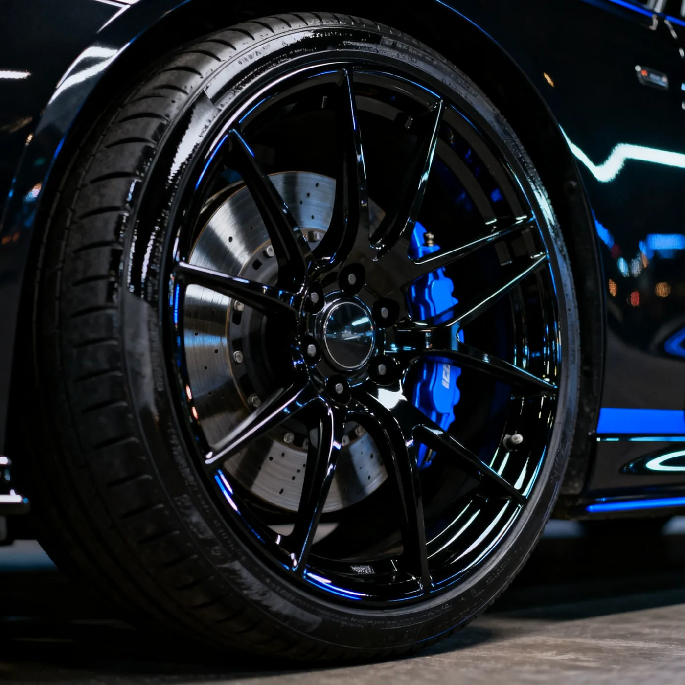 Polished gloss black alloy wheel with blue caliper
